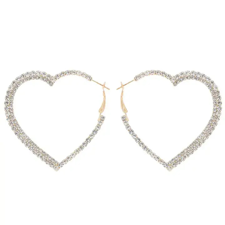 The Eternal Heart Gold Hoop Earrings feature heart-shaped hoops with sparkling rhinestones and gold-tone clasps, perfect for adding a romantic touch to any look, shown against a white background.
