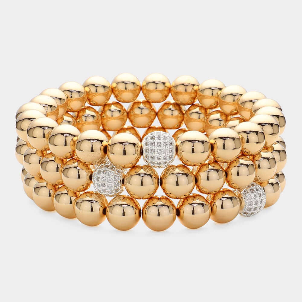 The High Society Stack - Gold 3 Piece Bracelet Set features bold, shiny gold beads with select beads sparkling with diamonds, arranged in three neat rows on a light background.