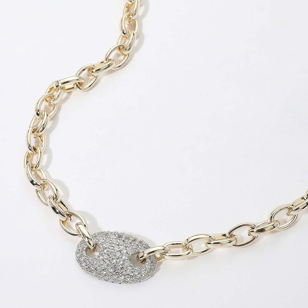 The Social Spark - 14k Gold Plated CZ Necklace features bold oval gold-dipped links and a central, larger oval pendant encrusted with sparkling pavé crystals. Shown on a white background.