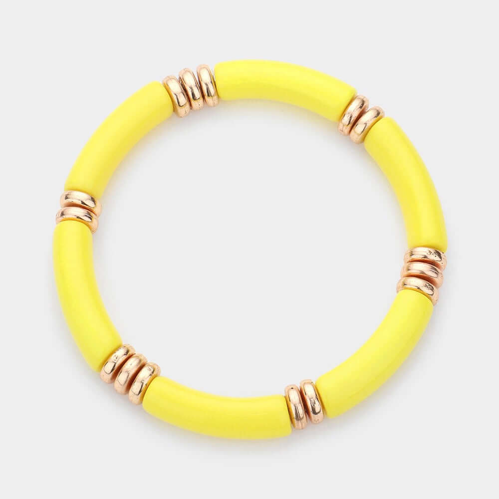 The Glow Frequency – Yellow Resin Stretch Bracelet features bright yellow tube-shaped resin beads with shiny gold rings in a stylish, stretch design, showcased on a white background. Now on sale!.
