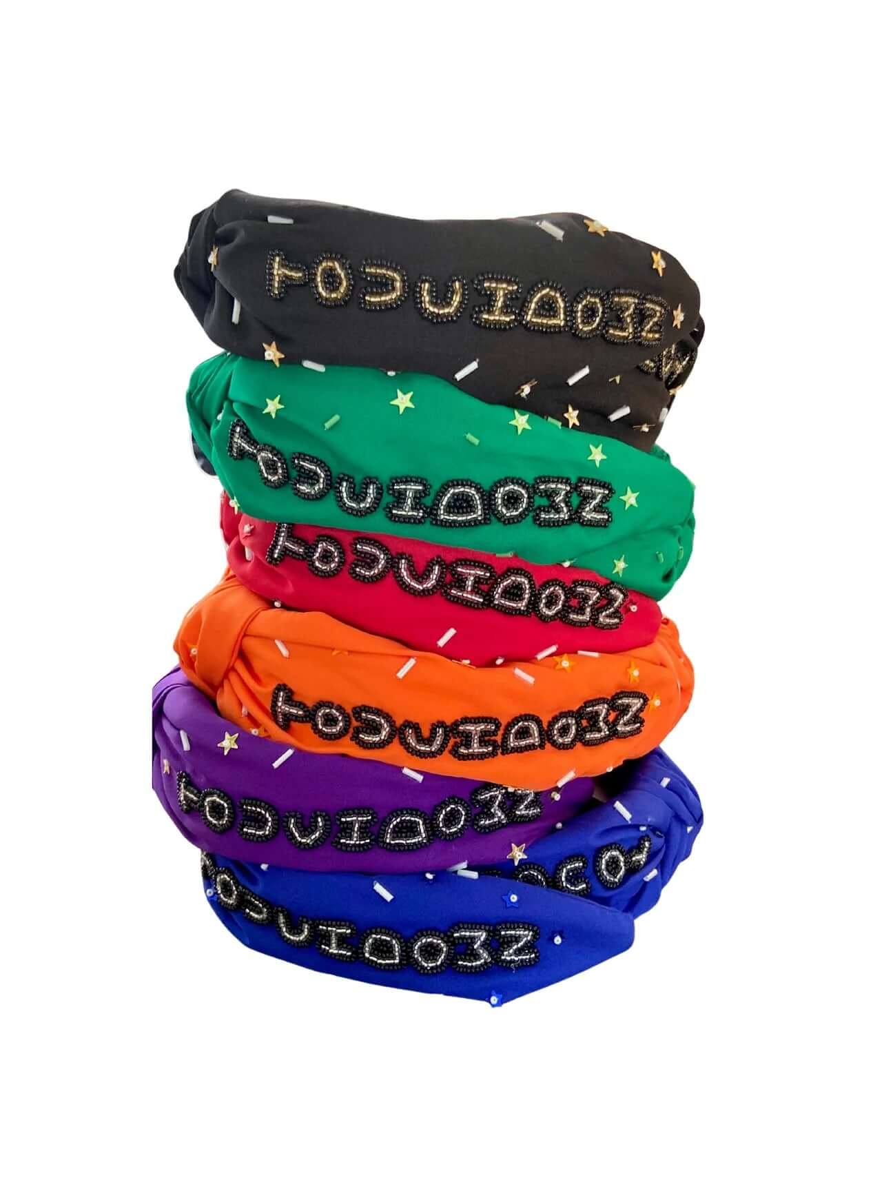 The Touchdown Twist - Red Touchdown Headband features colorful beads and star accents, making it the perfect game day accessory. Shown here in red with playful beaded patterns, set against a white background.