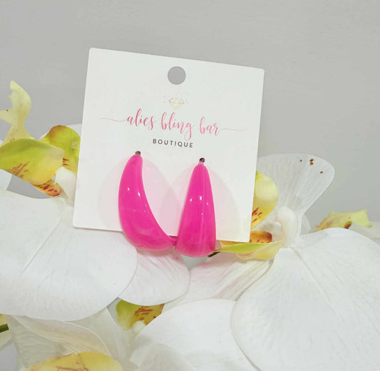 The Chaotic Chic - Hot Pink Acrylic Hoop Earrings are shown on an “alies bling bar BOUTIQUE” card, set against white and green artificial flowers—lightweight hoops perfect for bold, trendy looks.