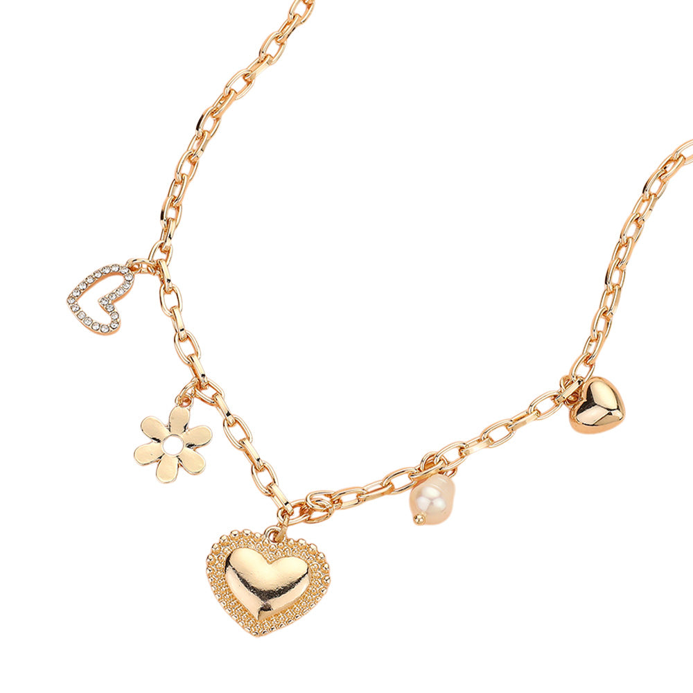 The Love Blossoms - Gold Charm Necklace features five charms—a rhinestone heart, flower, large gold heart, pearl, and small gold heart—elegantly arranged along a gold chain for a stylish jewelry statement.