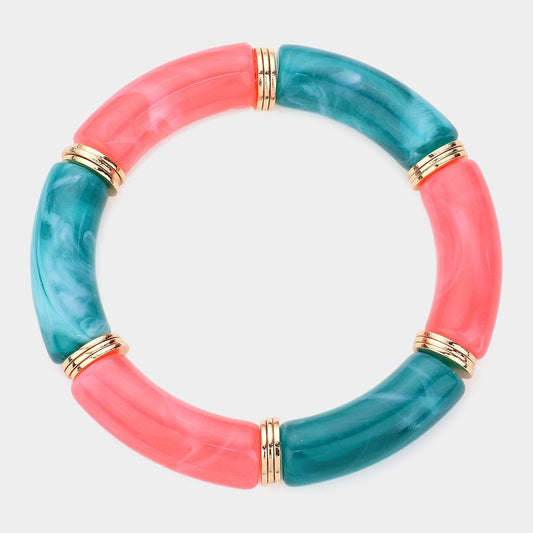 Exclusive to our boutique, the Luxe Rotation bracelet features alternating coral and green natural stone segments, accented with gold bands—crafted in a chunky circular design and showcased on a light background.