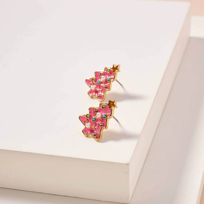 Pink and gold earrings on a white surface