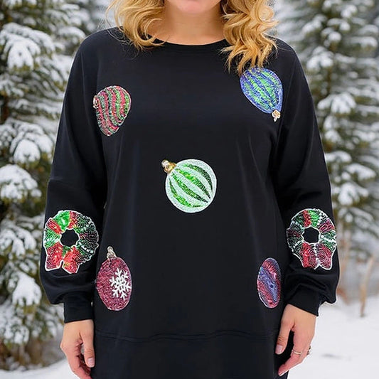 Woman wearing a black sweater with colorful fruit designs in a snowy forest setting