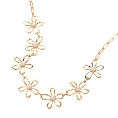 The Pure Bloom - Gold Flower Necklace features open-petal flowers, each centered with a pearl-like bead, elegantly spaced along the front for a look that radiates feminine charm.